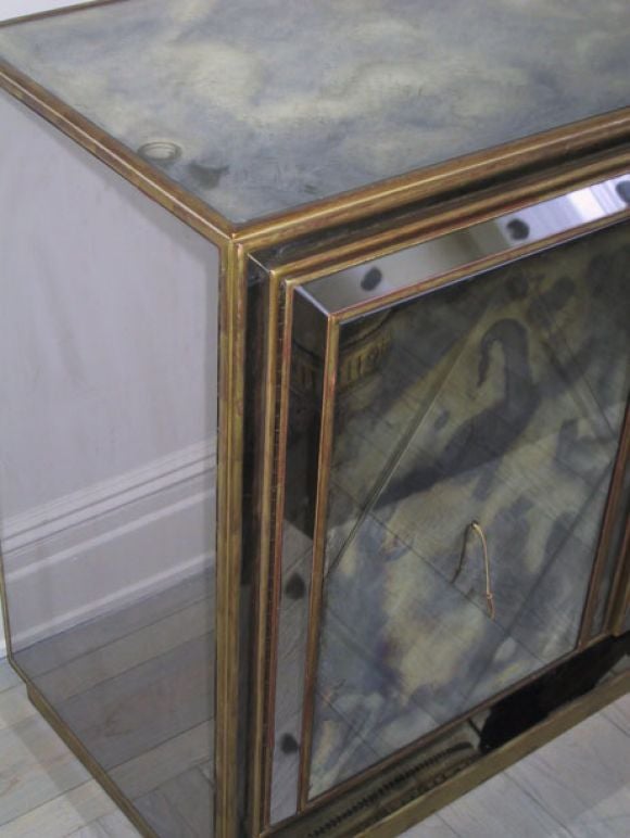 Elegant French Mid-Century patinated mirrored cabinet, commode, chest of drawers, console or credenza in the modern neoclassical style of Serge Roche. The piece has a diamond cut pattern engraved in each door. Inside there is excellent storage