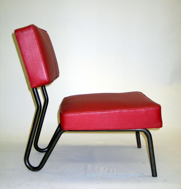 Rare, Chic Pair of Early French Industrial Modern Lounge / Slipper Chairs in tubular metal and red skai designed for the Paris headquarters of EDF-GDF by Jacques Hitier for Tubauto. The tubular metal structure has saber form rear legs and an open