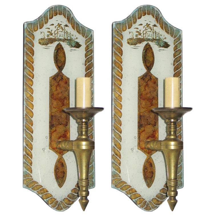 An exquisite pair of single arm wall lights with the glass back panels hand-painted featuring sober, elegant modern neoclassical imagery.