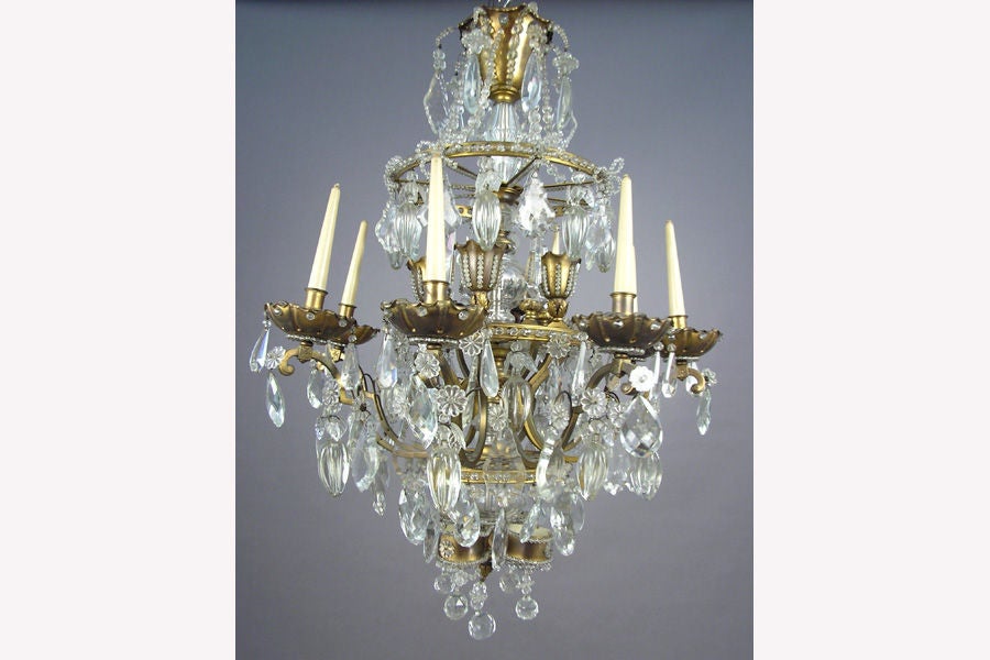 Elegant French bronze and cut crystal eight-candle arm chandelier / pendant in the modern neoclassical style of Louis XVI by Maison Bague`s for Maison Jansen with nine different forms of crystal.

Literature: See similar smaller model in Aguttes