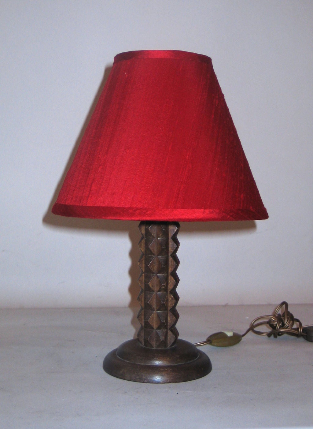 Pair of French, Louis XIII style lamps from the 1940 Period hand-carved in a Chevron Pattern and shown with a red silk shade. Ideal for a nightstand or a console. 

Shades are for demonstration only. Shade dimensions shown are: H 7" x Top D