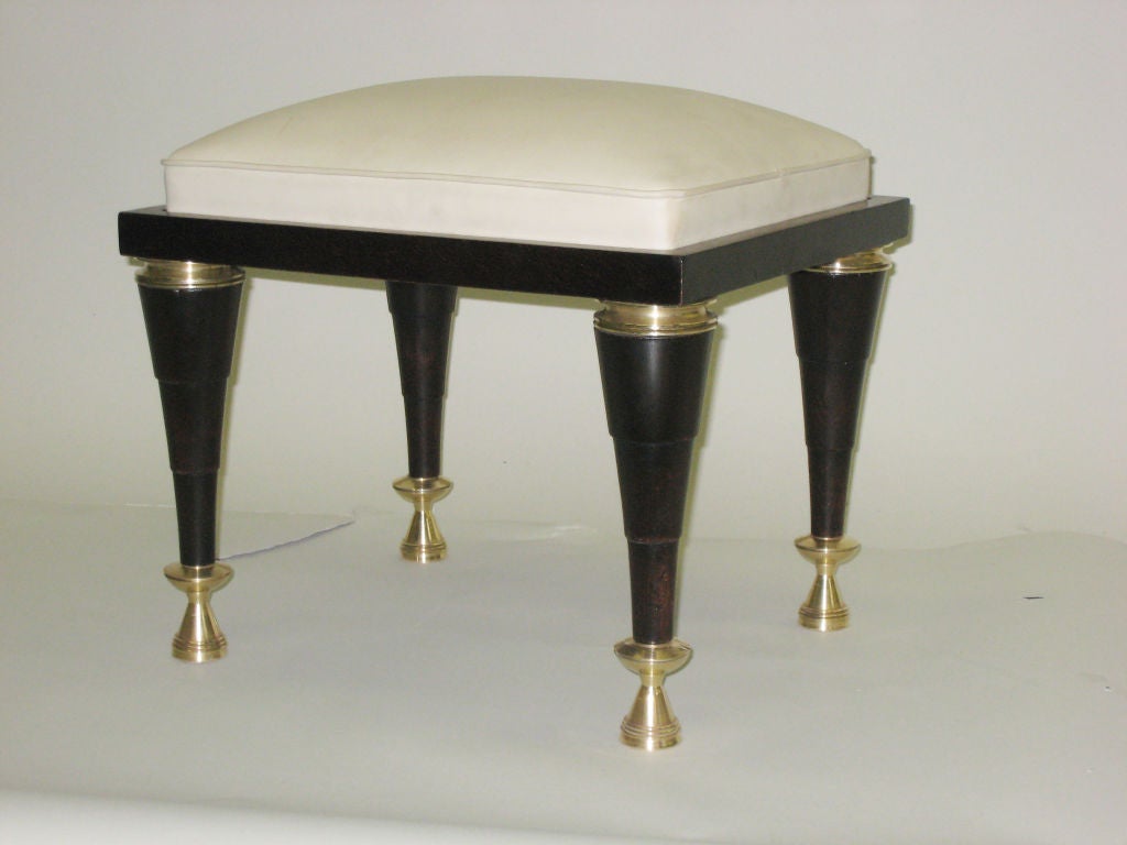 An important pair of stools/benches in Macassar d'Ebony in a post-modern/modern neoclassical spirit with solid bronze cornices and sabots. The elegant legs taper in a stepped fashion ending in solid bronze sabots and support a frame with inset