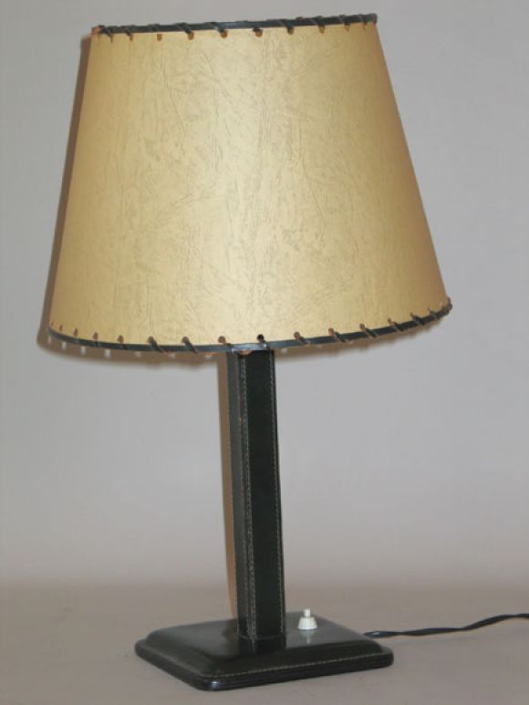 A Dark Green French Mid-Century Hand-Stitched Leather Table / Desk Lamp by Jacques Adnet in the Modern Neoclassical Spirit. Base and Stem are in Stitched Leather. Shade is in Parchment with Leather Trim. 

Documentation: Wright 20 Sale, Chicago,