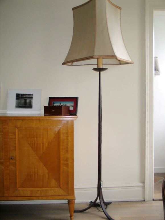 Pair of French hand-wrought iron standing lamps shown with large silk shades.