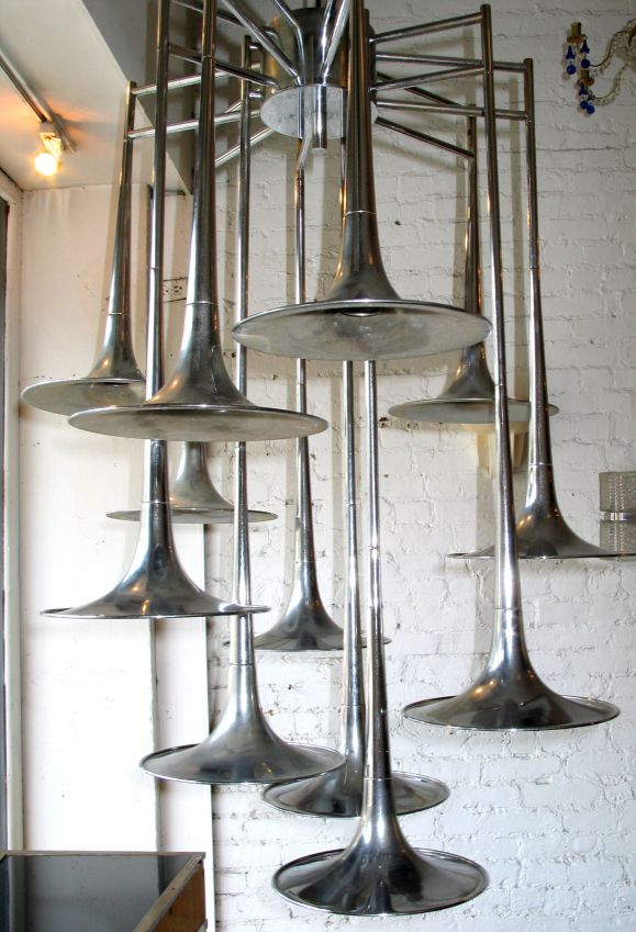 Large Italian twelve-arm nickel / chrome pendant / chandelier/ fixture by Reggiani 

Each arm is in the form of a trumpet. The piece is designed to accept 12 Edison sockets and can used with silver tipped bulbs to reflect light back upwards.