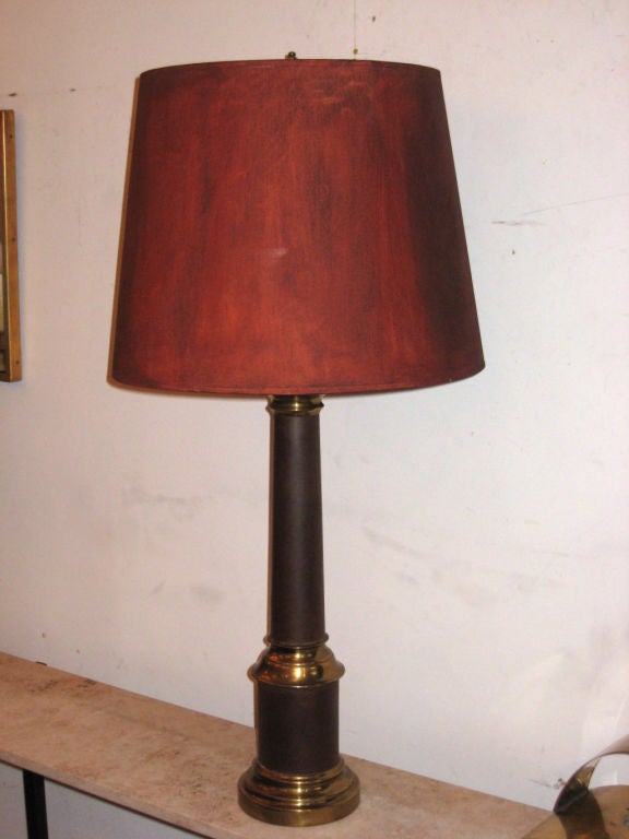 Elegant Pair of French Mid-Century Modern Table Lamps with the table lamp bases in maroon hand enameled metal and brass details. The pieces are complimented by hand-painted red shades. The entire piece emits beautiful filtered light.