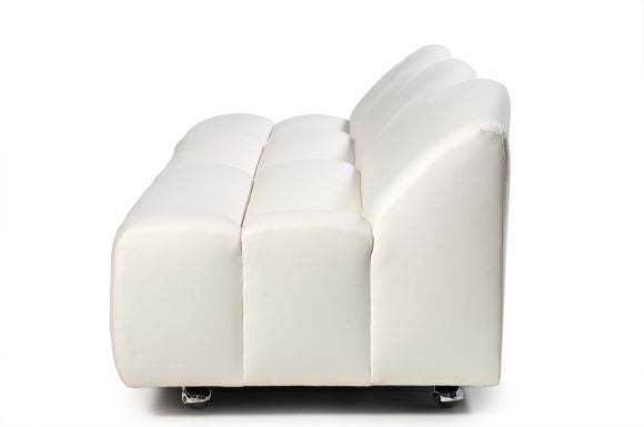 An “ABCD” settee composed of three seats of stylized waves recovered in ivory woolen jersey mounted atop chromed casters. designed by Pierre Paulin (b. 1927) and edited by Artifort. Reference: Anne Bony, 