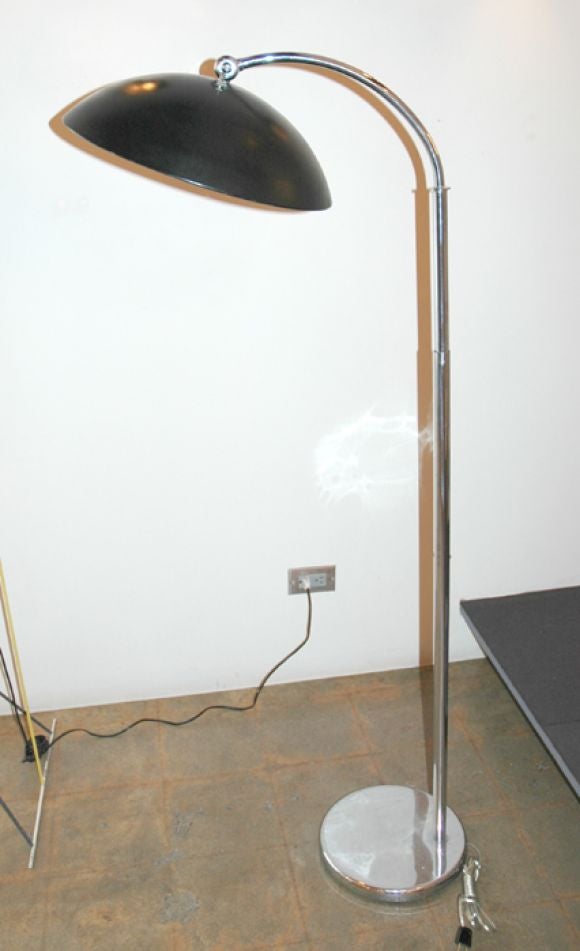 Greta Von Nessen floor lamp with Bakalite detail.  Adjustable height and pivoting hood. May be utilized as directional downlight or as a torchier.