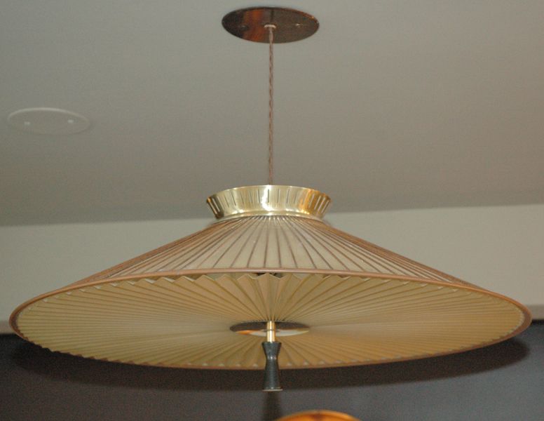 multi-material hanging fixture for Lightolier..slitted brass and perforated metal upper diffuser, parchment 'skin', accordian pleated diffuser (plastic), on/off finial at center of pleats, bamboo details