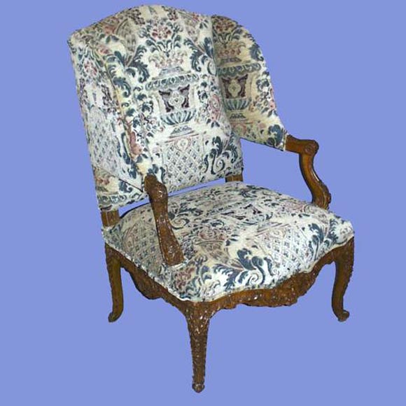 French 19th century finely carved and upholstered wing chair.