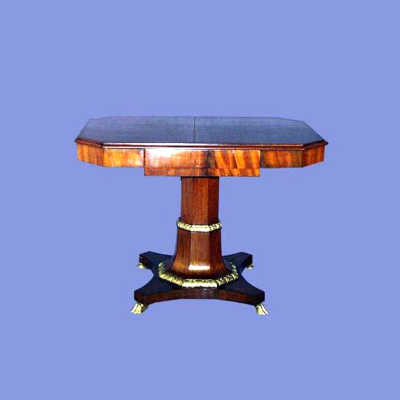 Fine 19th century figured mahogany Baltic center table with pedestal base supported by gilt lion feet.<br />
FOR MORE INFORMATION, PLEASE VISIT WWW.CONNOISSEURANTIQUES.COM