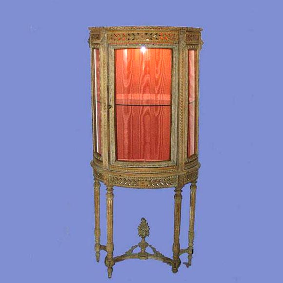 19th century carved bow-front glass vitrine on stand, electrified interior.<br />
FOR MORE INFORMATION, PLEASE VISIT WWW.CONNOISSEURANTIQUES.COM