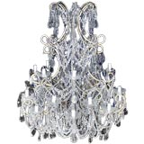 Antique Italian swag crystal chandelier with tiered candleholders.