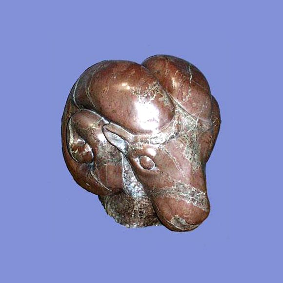 Large carved veined marble figure of a rams' head.