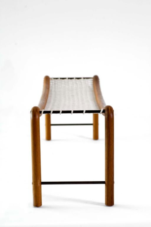 Solid teak frame with blued brass rods and woven cotton seat.  Seat height measures 16.5
