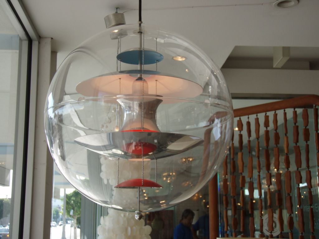 Plastic sphere with red, blue & chrome details inside.  Quite a stunning light.  Retains original Louis Poulsen sticker inside, whom helped collaborate on this piece with Panton.