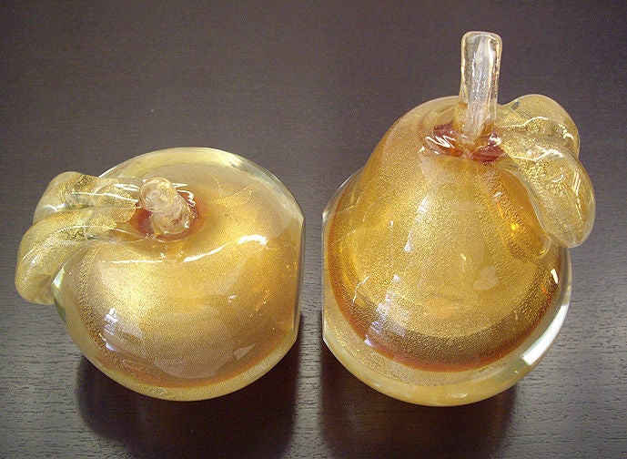 Gold glass pear and apple bookends. Paper tags reads Venetian Glass, Made in Murano, Italy. The pear measures: 7H, apple: 5H Diameter is 5