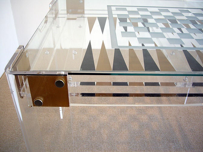 Clear game table for chess, backgammon or other table games. Glass top has etched chess board. Top lifts off for backgammon. Frame and legs are Lucite. Top quality design and craftsmanship.