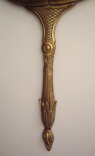 Hanging wall mirror that looks like a hand mirror. Metal and mirror. Signed Palladio