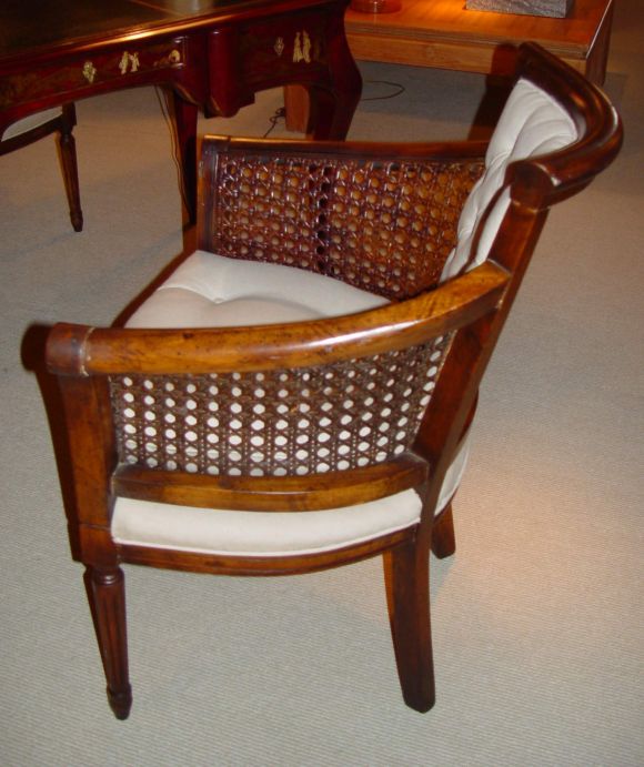 Confortable curved armchairs with cane on each arms from France circa 1890<br />
Newly upholstered.