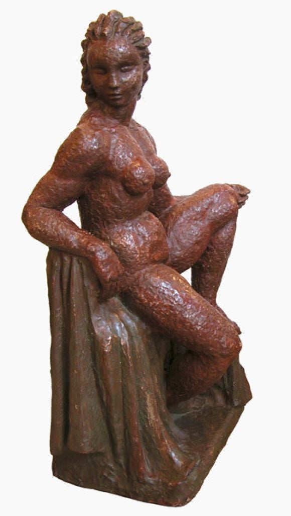 An important French 1940's terra cotta sculpture of a seated nude woman; with head turned to the right above a voluptuous torso; Signed 