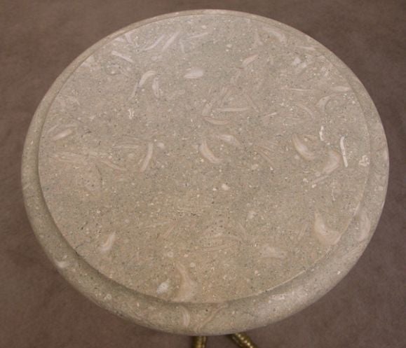An unique and whimsical French bronze ostrich leg-form side table with circular pale green fossilized granite top; the well-detailed, slender ostrich leg support below a later fossilized granite top