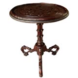 A Carved Swiss Black Forest Circular Tripod Table