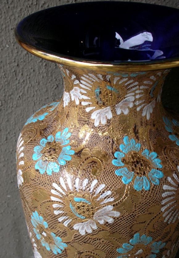 A large-scaled and striking pair of English urn-form stoneware vases; each of gray stoneware richly laced with textured glazes and enamels in dark brown, white turquoise and gold; inside of lip and bases in colbalt blue; marked 