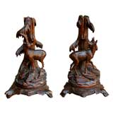 A Pair of Swiss Black Forest Carved Wooden Candle Holders
