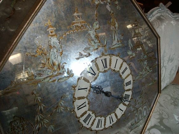 Very unusual eglomise chinoiserie octagonal wall clock with electric chord in back.