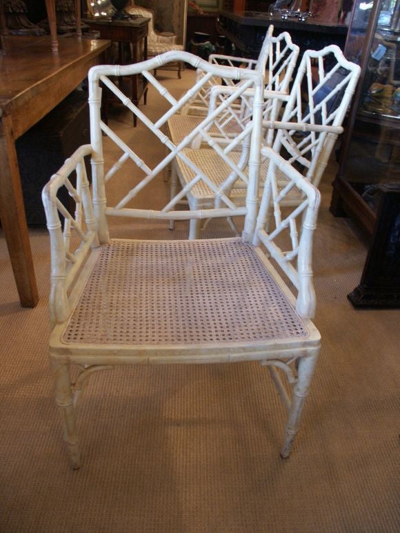 Classic set of well made and nicely carved cane and wood faux bamboo arm chairs with painted finsh