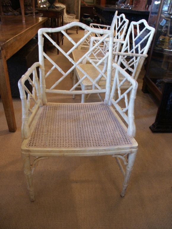 Classic set of well made and nicely carved cane and wood faux bamboo arm chairs with painted finsh