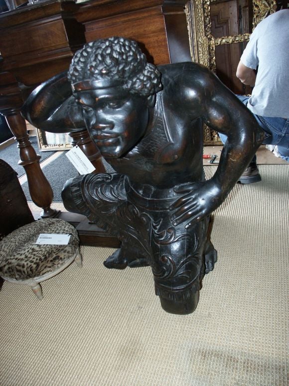 Unusual large carved wood figure with dark stained finish.  This would make a great console table.