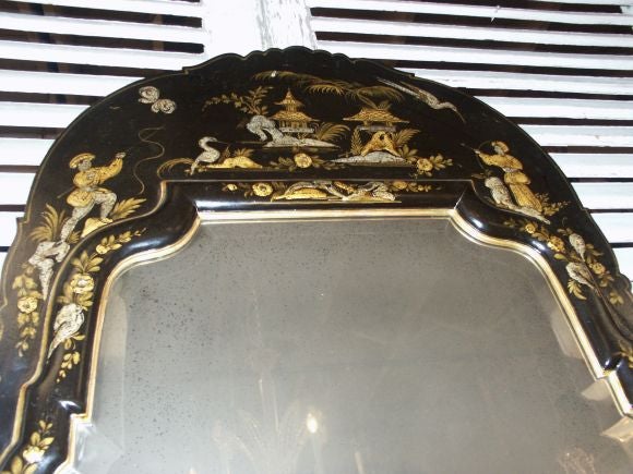 Great looking really well done antiqued glass mirror plate and raised chinoiserie painted finish.