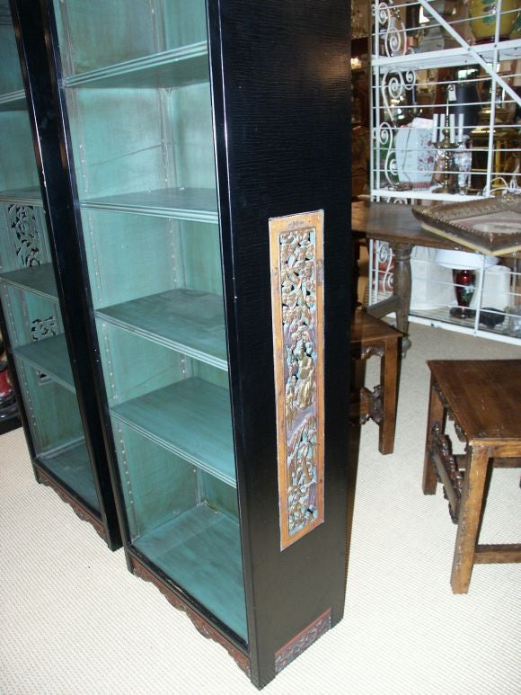 great looking tall narrow pair of bookcases with antique chinese carved fragments....these would make greatcabinets to display a collection