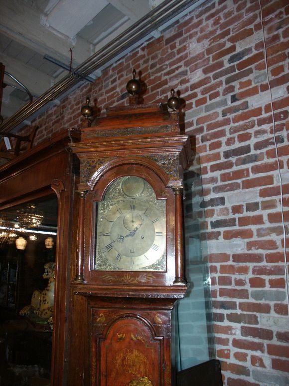 Beautiful scarlet tall case clock by James Smith with domed pagoda form fretwork carved bonnet supporting three turned finials centering an arched glazed door flanked by columns, the bonnet sides with glazed panels: the engraved brass dial with