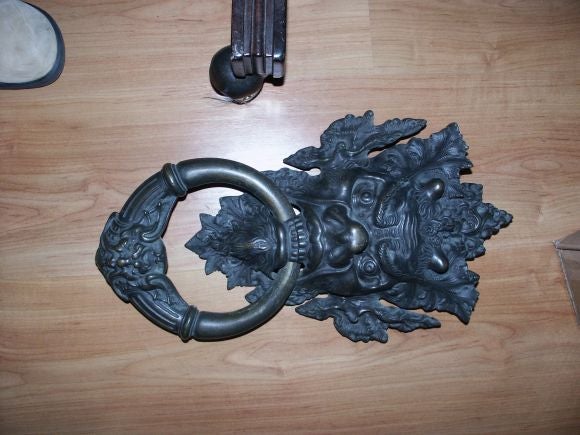 Great looking massive door knocker with ornate masked creature and heavy bronze ring