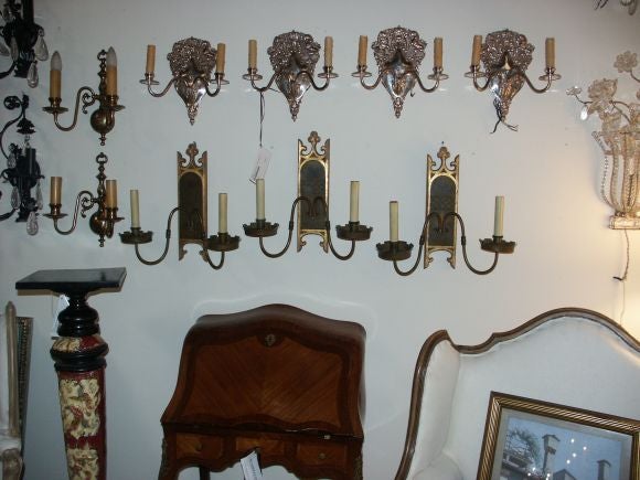 Gothic or tudor style wall sconces (3)  with later added carved giltwood wall plaques.