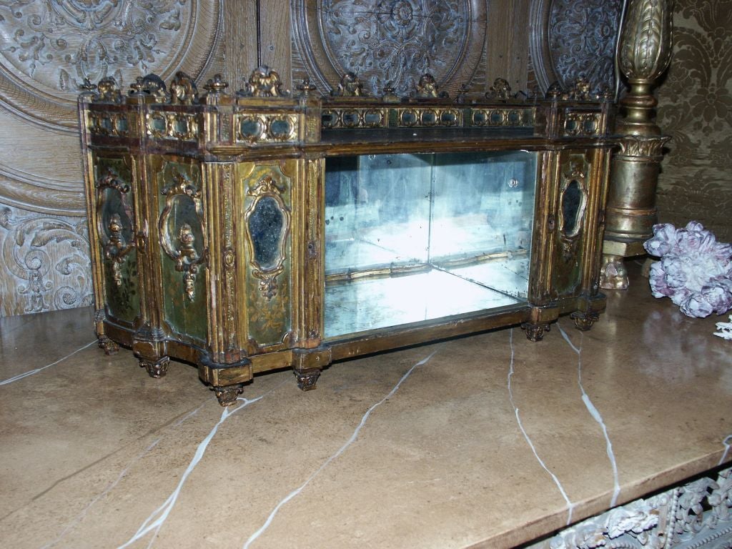 Amazing 18th C Italian with later added internal mirrors miniature room facade now mounted as a hanging cabinet with two doors that flank an open center area(where 20th C mirror was added). This is hand painted with parcel gilt and amzing little