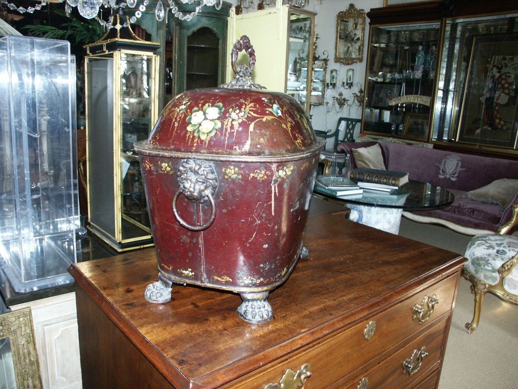 Dark Burgandy Covered Oval Tole Coal Scuttle with Painted flowers and unusal Shaped Iron handle on top with lion mask ring handles and lion paw feet.  English Pontypool japanned coal tureen