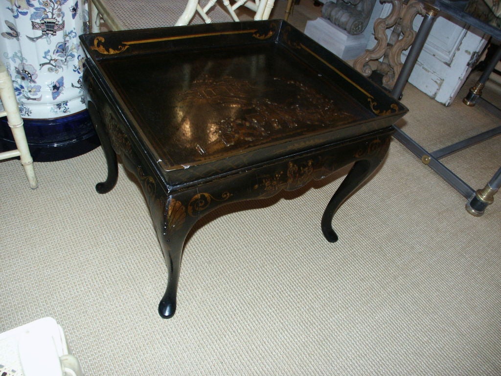 Black Papier Mache Tray on Queen Anne base decorated with Chinoiserie Garden Court Scenes.  Underneath side of tray embossed with conjoined monogram.  English, Circa 1840 Chinese style coffee table