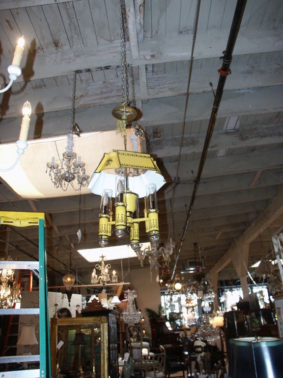 great looking tole bouillotte hanging lantern with paint decorated finish and glass shades and drip cups.