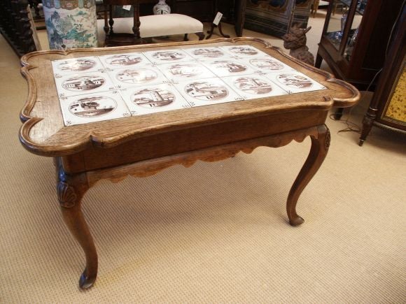Highly decorative scalloped coffee table with Antique delft tiles.