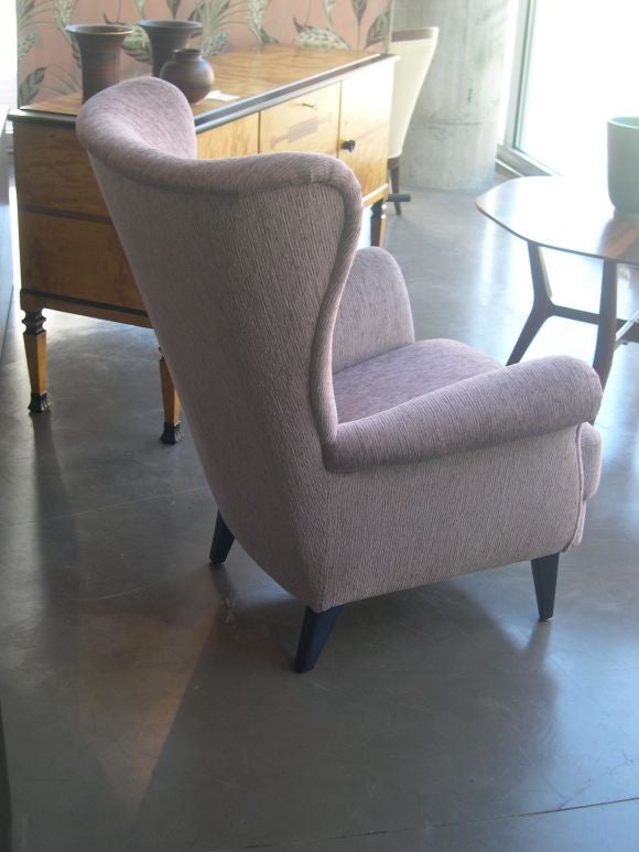 Swedish Modernist Wing Backed Chair covered in lavender chenielle. Ebonized birch legs.