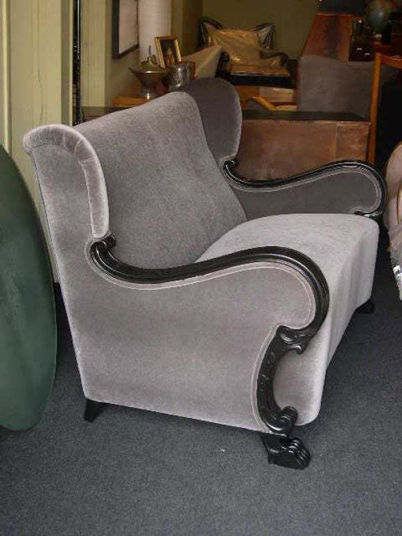 Swedish neo-gothic wing backed sofa with carved ebonized birch arm/legs.<br />
Completely restored and recovered in grey mohair velvet.