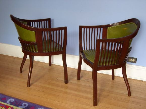 Pair of Swedish jugendstil chairs in mahogany recovered in pea green leather.
