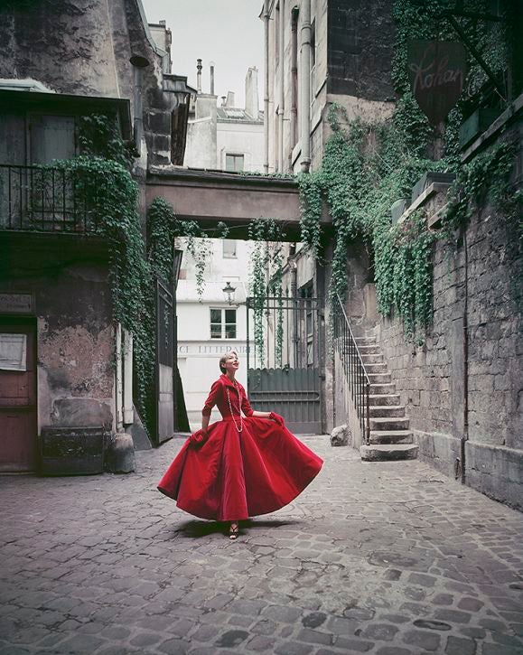 Shot in a Paris courtyard, a model is seen wearing a red Chanel velvet gown, 1955. This image is an outtake shot by Mark Shaw for a fashion assignment for LIFE magazine and was never intended for publication. This work is available exclusively