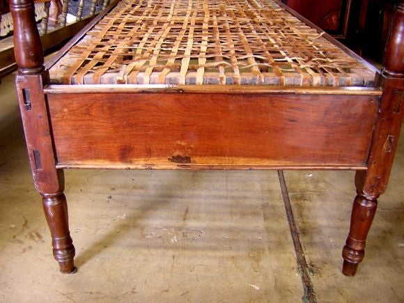 Extraordinary wooden bed with weaved leather bottom and posts. Twin mattress will fit. Wood and leather have beautiful patina.