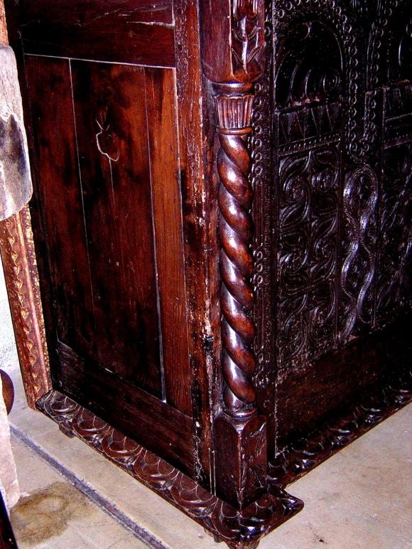 Carved sacristy chest dated 1675 with intricate carving. Opens in front with two doors and has one shelf inside.