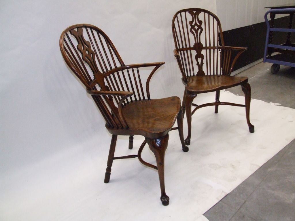 Rare pair of English Thames Valley yewwood windsor armchairs from the Queen Anne Period, the pierced backsplats over shaped elm seats, the cabriole legs joined by curved stretchers, both with excellent colour.  Very characterful pieces.